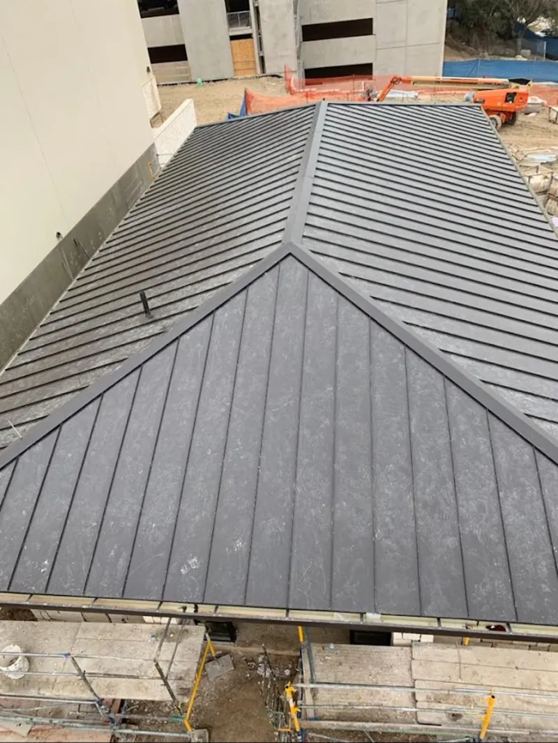 Commercial metal roof construction with crane equipment in Kenwood