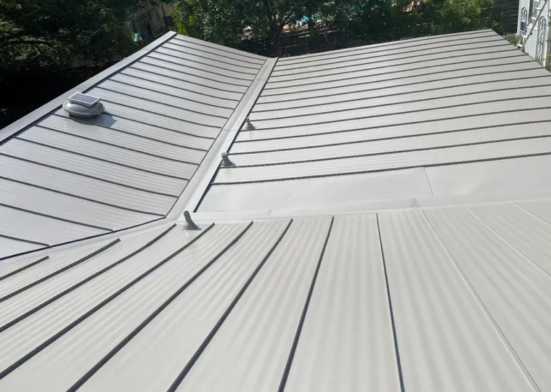 Solar attic fan installed on a metal roof for Roof Ventilation in Kenwood